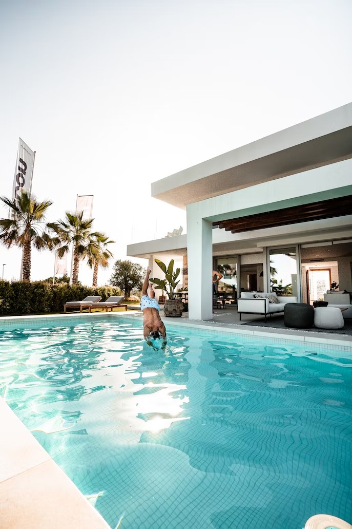 A man jumping in a gorgeous swimming pool